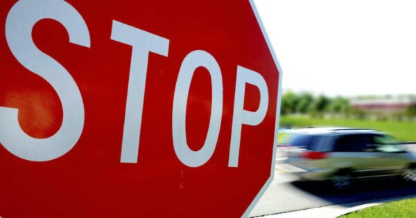 Car zooming through a stop sign